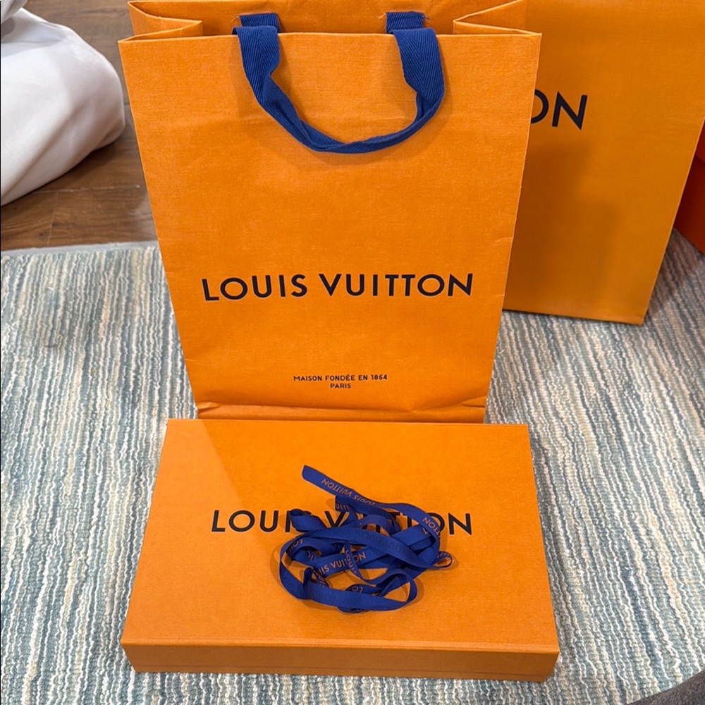 Louis Vuitton Orange magnetic box with shopping bags and ribbon.
